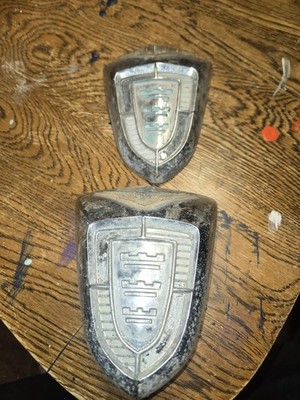 1956 Chrysler Windsor emblems, very nice condition part #1598602 & part #1624436
