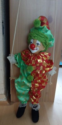 porcelain clown doll on swing
