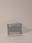 Silver vintage Lucite Empire State Building miniature souvenir with blue text reading “MADE IN U.S.A.” on white background.