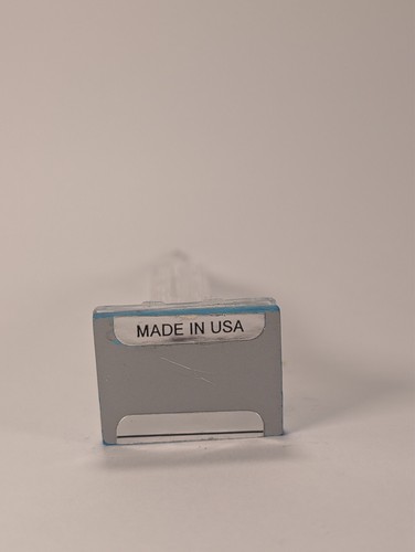 Silver vintage Lucite Empire State Building miniature souvenir with blue text reading “MADE IN U.S.A.” on white background.