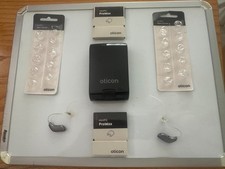 A pair of Oticon MiniRITE Ruby 1 model battery operated Hearing Aids