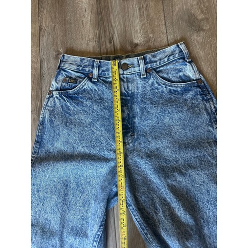 Light blue vintage Lee high-rise mom jeans size 8 with faded thighs, five-pocket design, and yellow measuring tape.
