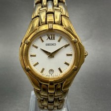 Reloj Seiko Mujer 26mm Esfera Blanca Tono Dorado Fecha V789-0369 Batería Nueva JKKJ