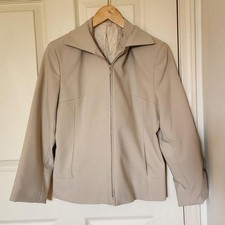 Vintage tan zip-up blazer jacket with zipper, pockets, and shoulder pads