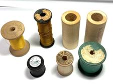 7 wooden spools various sizes tan green black partial silk thread1 1/4' - 2 1/2"