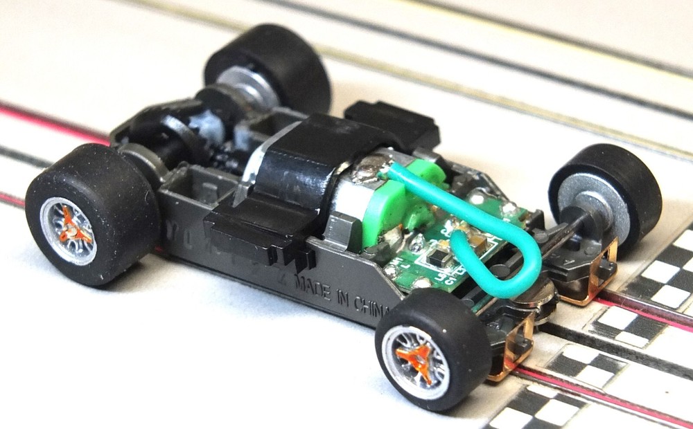AFX Mega-G 1.5-inch Short Wheelbase Chassis with Orange Knockoffs and Body Clip