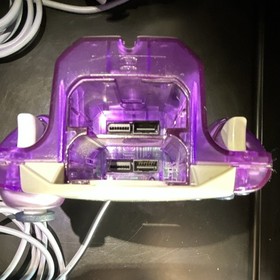 2  SEGA Dreamcast Controllers.  1 White and 1 High Frequency Purple controller. 
