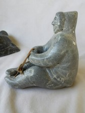 INUIT SCULPTURE OF FIGURE FISHING WEIGHS ABOUT TWO POUNDS