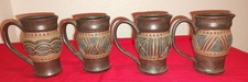 4 rustic, handcrafted ceramic mugs with a car...