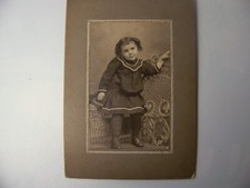 Cabinet photo of young girl from the early 1900s Dress and curls from era.