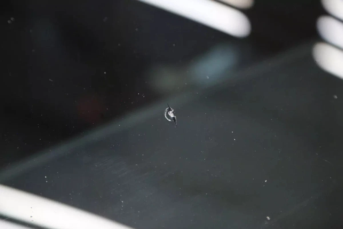 A small chip in a vehicle's windshield.