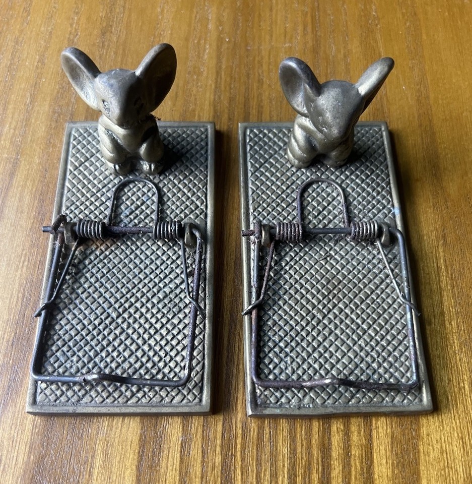 A tiny brass mouse caught in a mousetrap — that's also a functioning paper clip holder — is peak desk humor meets vintage craftsmanship.