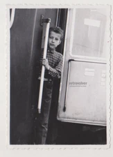 Cute Young Boy on the Edge of Adventure, Holding Onto Dreams and Moving Train