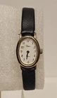 Vintage Timex Quartz Oval Gold Tone Dress Watch White Arabic Dial Black Strap