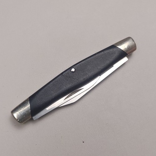 Black-handled Buck 309 slipjoint pocket knife with silver 420HC steel blades on a gray background.
