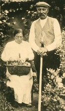 GRANDPARENTS IN MATURE GARDEN. TONED SILVER PRINT. 