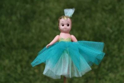 kewpie doll on stick