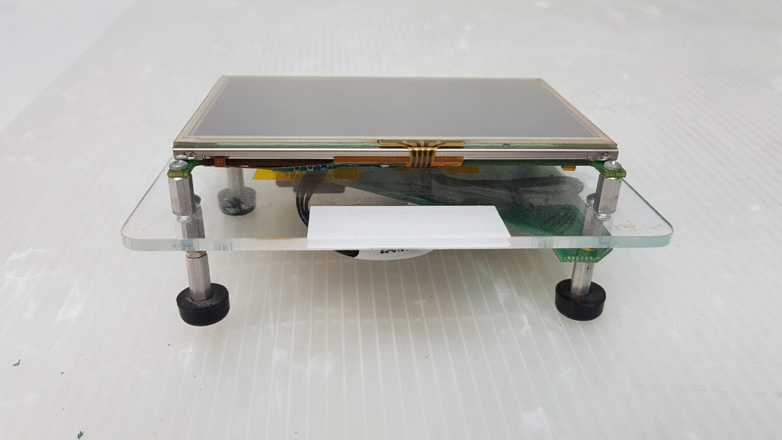 Side view of the Reach touch screen kit on acrylic stand with rubber feet