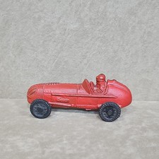 A vintage red cast iron Hubley race car with a molded driver.