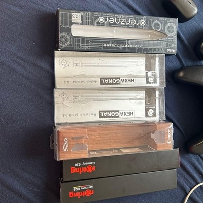 Empty mechanical pencil box. Boxes with paper have writing on them. Runrun