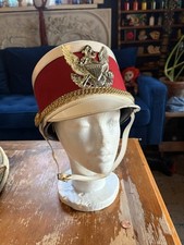 vintage marching band shako hat featuring a crimson red body