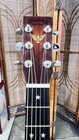 Brown Martin D-76 limited edition guitar with gold eagle head, silver hardware, and six white star and dot markings on fretboard.
