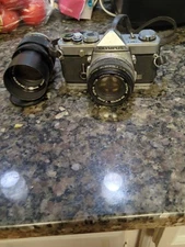 olympus Om-1 camera witha telephoto lense included