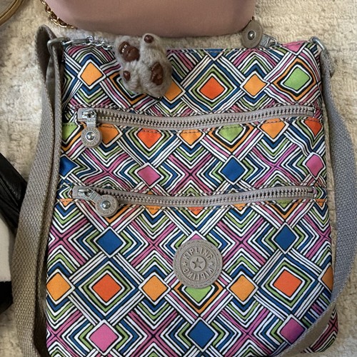Seven kids’ purses with colorful geometric patterns, including Kipling, Nicole, and Target designs.