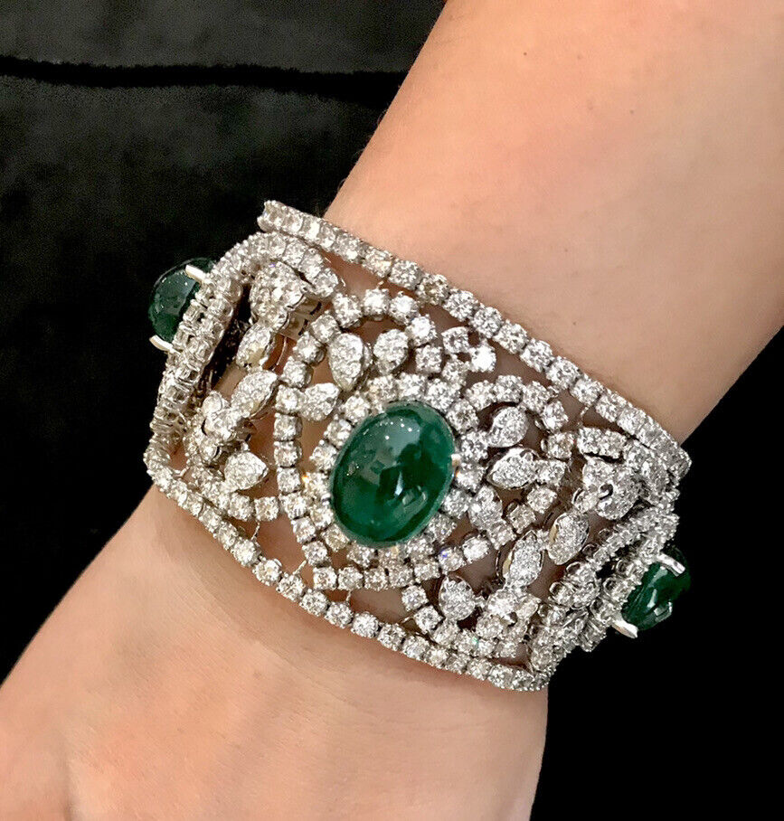 Lot - Sterling silver and 18K gold cuff bracelet mounted with cabochon ruby  and emerald stones. Unmarked.