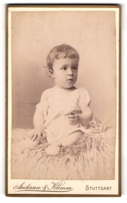 Photography Andersen & Klemm, Stuttgart, cute toddler in shirt sitting on fur 