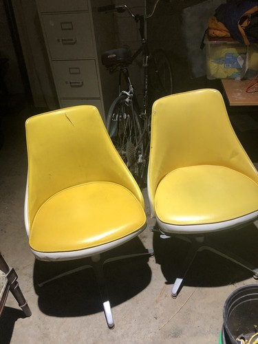 +2This is a pair of vintage mid-century modern yellow vinyl swivel chairs