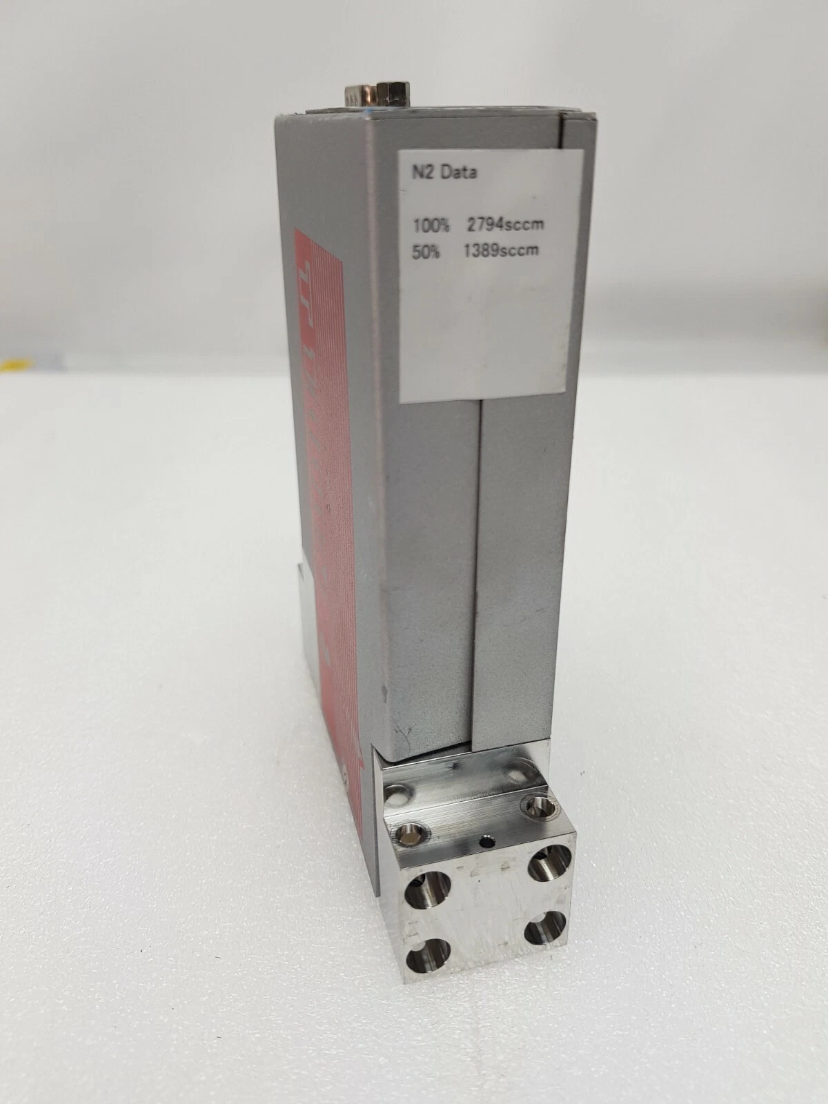 Side of the Fujikin MFC with N2 data label and flow block
