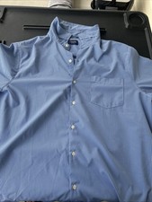 Chaps men's dress shirt features a classic blue gingham check pattern