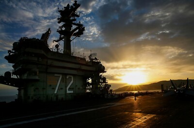 Sun sets over the aircraft carrier USS Abraham Lincoln CVN-72 Photo Print