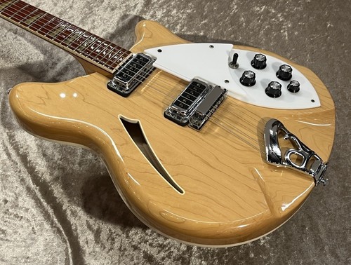 Light maple Rickenbacker 360 MG with white pickguard, silver hardware, and three-quarter chop.