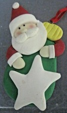 CLAY-DOUGH CHRISTMAS ORNAMENT SANTA HOLDING A CHRISTMAS ORNAMENT
