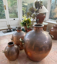 Three large decorative Egyptian copper "ful" cooking pots.