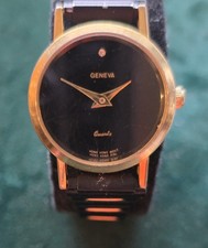 Geneva quartz watch features a minimalist black dial with a single diamond