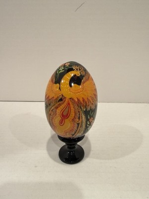 Traditional hand-painted Firebird Slavic Easter egg on a matching pedestal stand