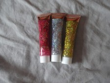 Three tubes of face and body glitter- Red, Silver and Gold