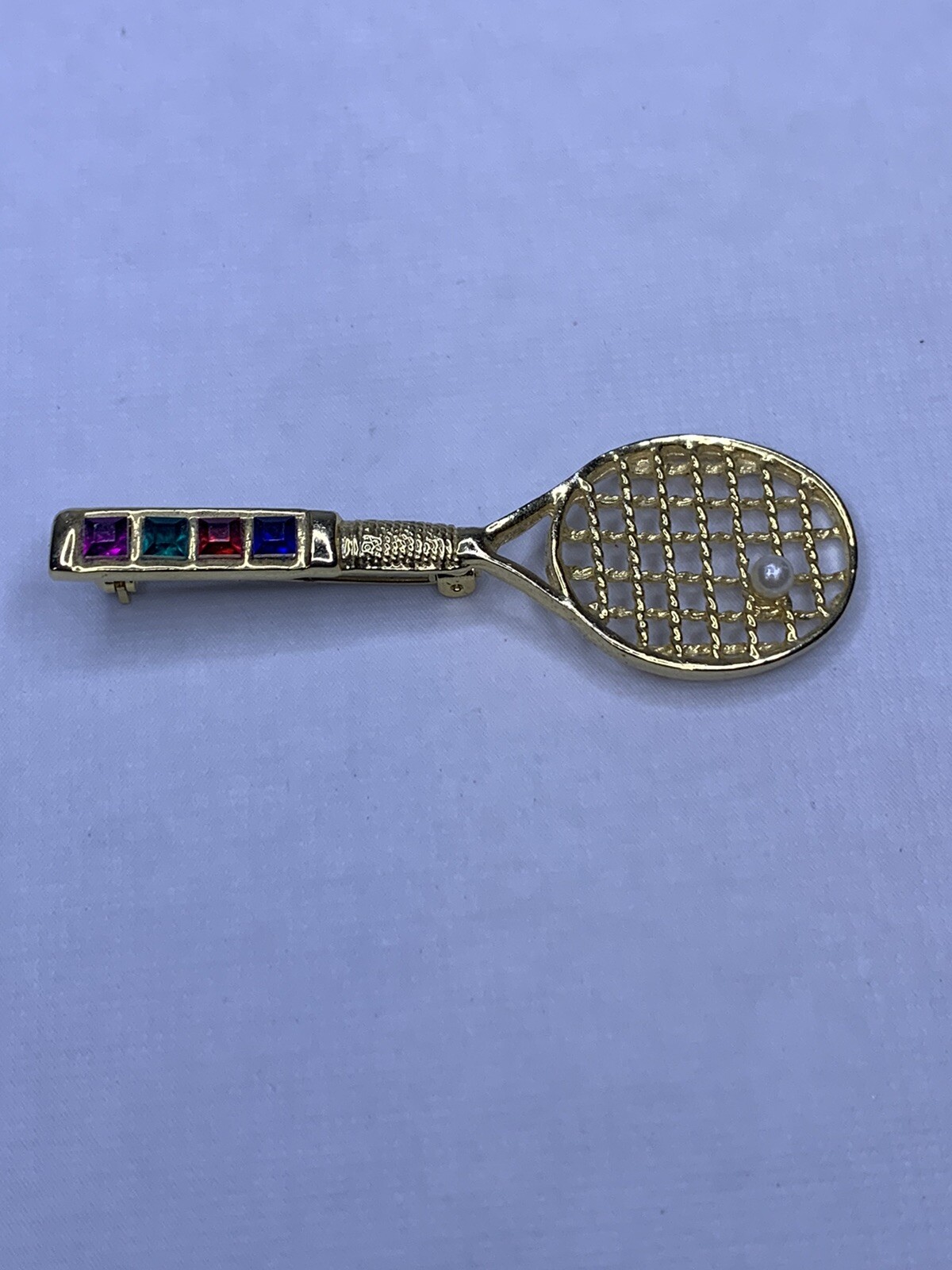 Tennis racket with faux peral roach pen with colored rhinest