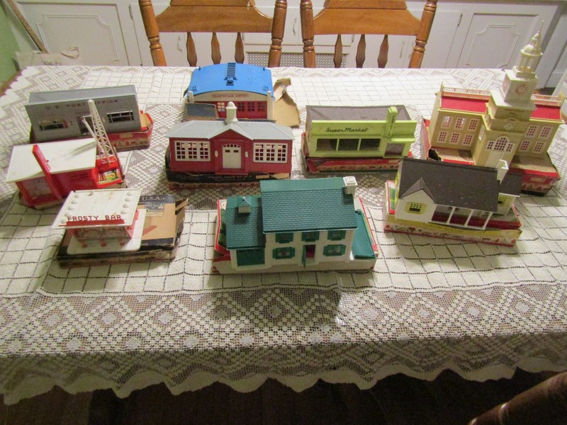 LOT OF NINE VINTAGE PLASTICVILLE BUILDINGS AND BOXES