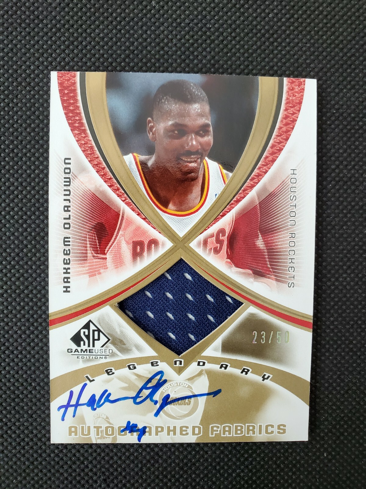 2005-06 HAKEEM OLAJUWON SP GAME USED SPGU LEGENDARY AUTO FABRICS INSERT #23/50!