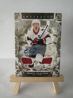 2024-25 Upper Deck Artifacts-Brady Tkachuk #127 Gold Auto Material /45 (AU, MEM)