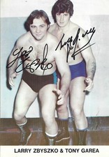 M3713  Tony Garea Larry Zbyszko signed Wrestling Magazine Page w/COA