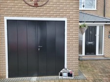 Supplied and fitted Black Novoferm mid Vertical rib Side hung garage door