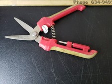Fiskars Brand Garden Pruner With Red and Tan Handles.