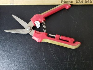Fiskars Brand Garden Pruner With Red and Tan Handles.
