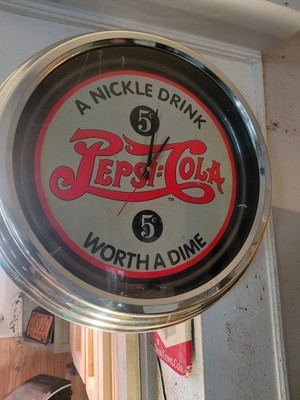 This is a reproduction Pepsi-Cola advertising clock, known as a ''double bubble''