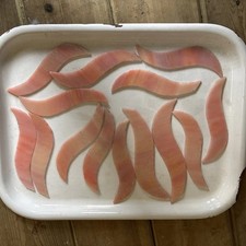 14 Shaped Pieces Of Peach Colored Iridescent Stained Glass, Suitable For Crafts.